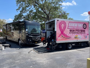 RV tire service performed by Extreme Tires. You can see a pink truck promoting the fight against breast cancer with the Extreme Tires logo